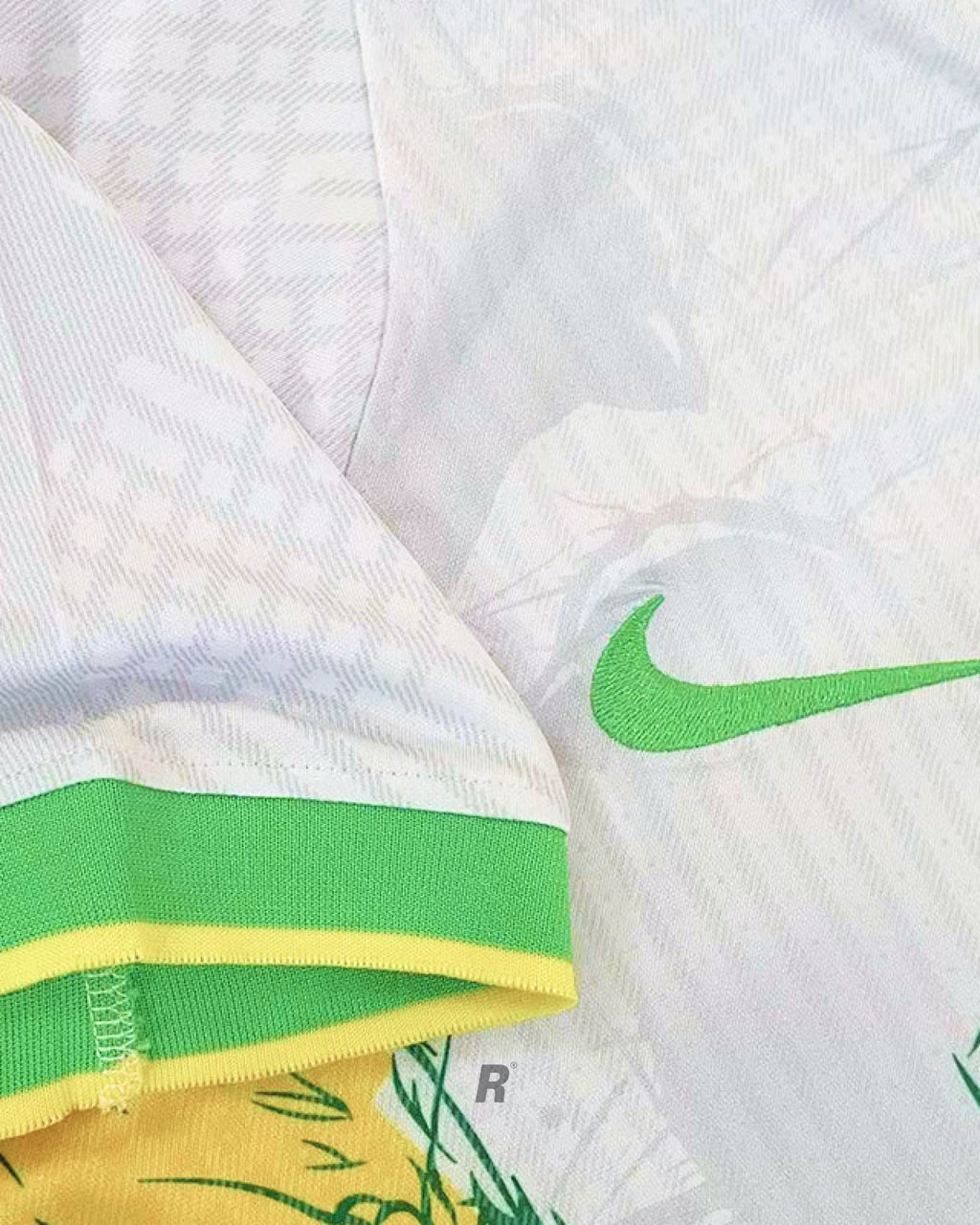 Highlighting the white fabric and breathable material of the Brazil Birds Concept Jersey, with subtle yellow bird motifs and premium stitching.