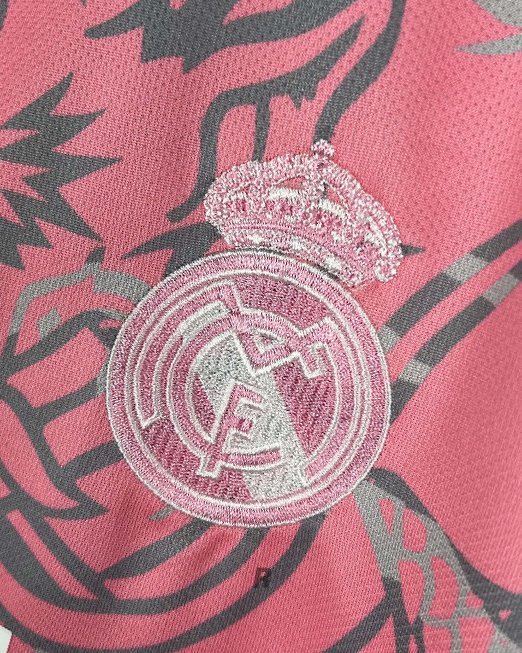Focus on the striking pink dragon motifs of the Real Madrid Pink Dragons Jersey. High-quality, detailed, and built to impress.